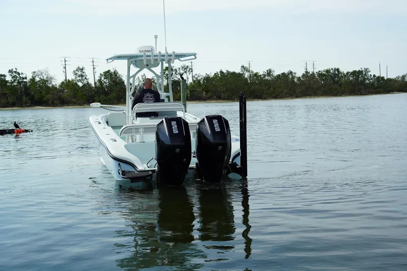 Slide: The Image of 2020 Yellowfin 26 Hybrid boat with dual engines on calm water. - 4