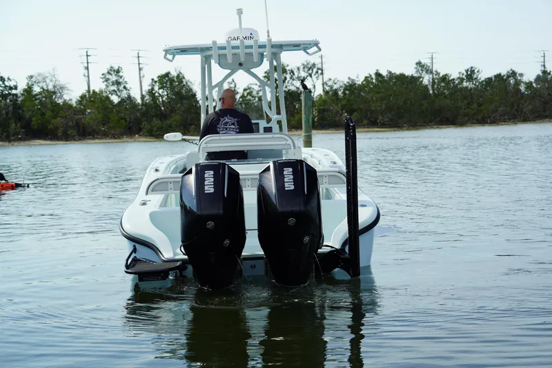 Slide: The Image of 2020 Yellowfin 26 Hybrid boat with dual outboard engines on calm water. - 5