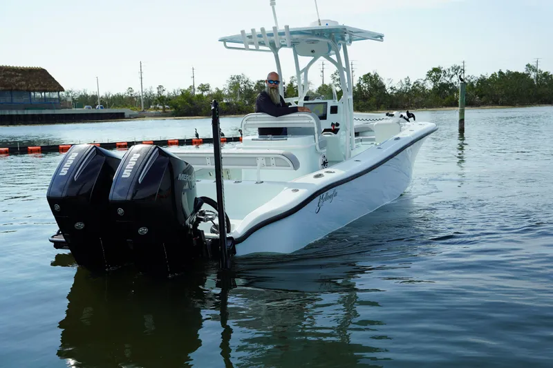 Slide: The Image of 2020 Yellowfin 26 Hybrid boat with dual engines on calm water. - 6