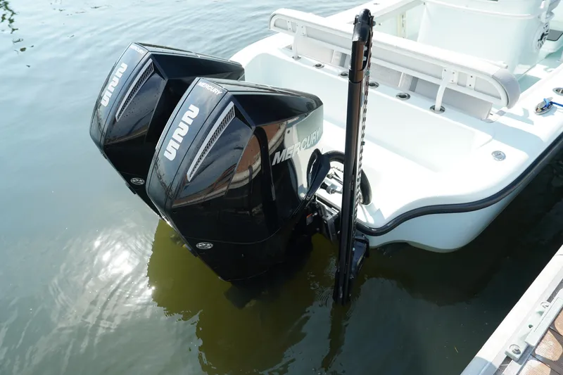 Slide: The Image of 2020 Yellowfin 26 Hybrid boat with dual Mercury outboard engines on water. - 7