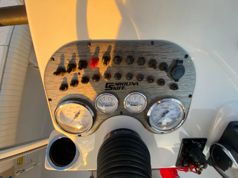 Slide: The Image of Control panel of a 2017 Carolina Skiff Sea Skiff 21CC boat with gauges and switches. - 17