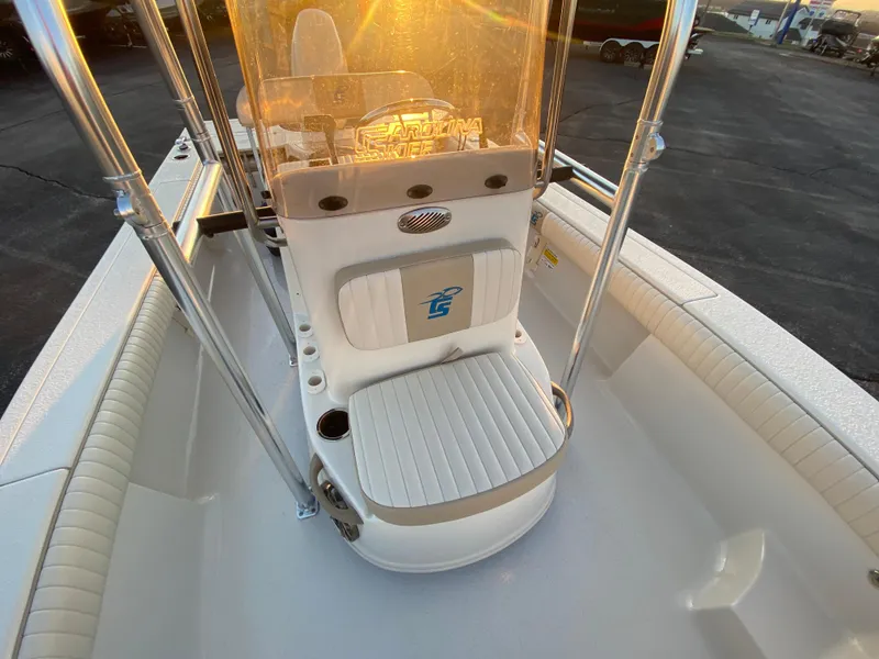 Slide: The Image of 2017 Carolina Skiff Sea Skiff 21CC boat interior with seating and console at sunset. - 21