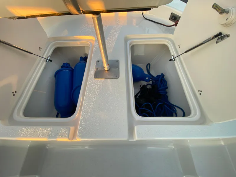 Slide: The Image of 2017 Carolina Skiff Sea Skiff 21CC storage compartments with blue fenders and ropes. - 25
