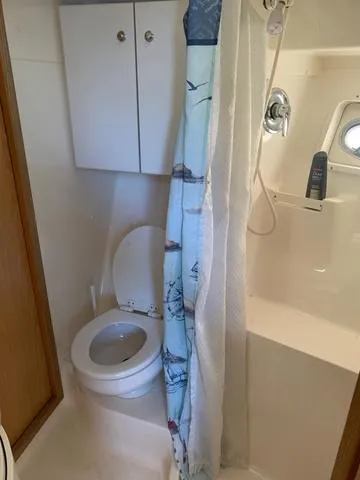 Slide: The Image of Bathroom interior of 1999 Tiara Yachts 3500 Express with shower and toilet. - 10