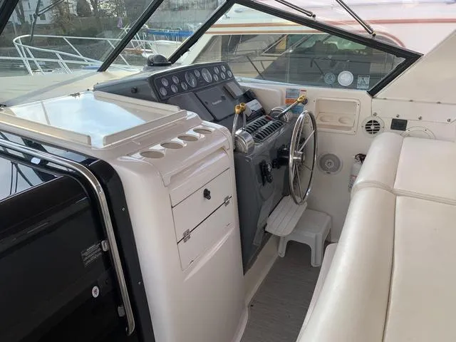 Slide: The Image of 1999 Tiara Yachts 3500 Express helm with steering wheel and control panel. - 14