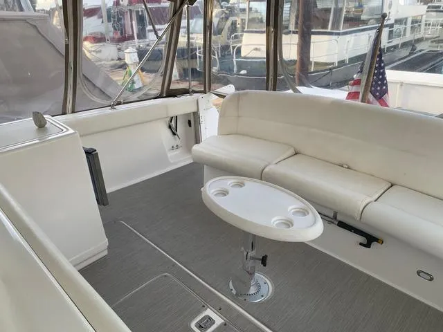 Slide: The Image of 1999 Tiara Yachts 3500 Express interior with white seating and table. - 15
