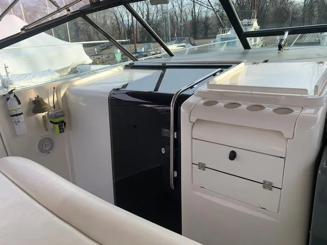 Slide: The Image of 1999 Tiara Yachts 3500 Express cockpit with storage and seating area. - 17