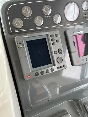 Slide: The Image of 1999 Tiara Yachts 3500 Express dashboard with navigation equipment and gauges. - 21