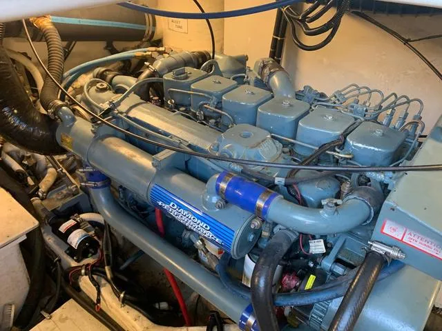 Slide: The Image of Engine compartment of a 1999 Tiara Yachts 3500 Express, featuring a marine diesel engine. - 5