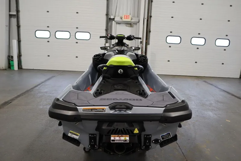 Slide: The Image of 2025 Sea-Doo RXT-X™ 325 in Ice Metal and Manta Green, rear view in garage. - 17