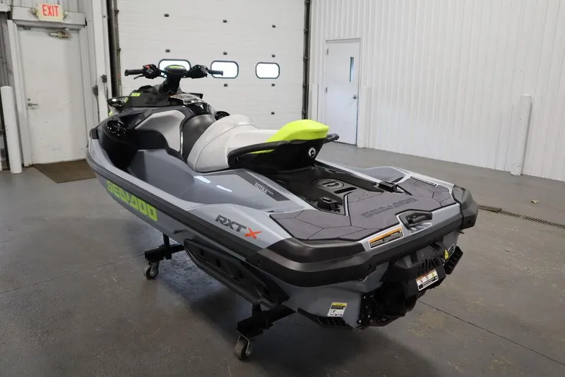 Slide: The Image of 2025 Sea-Doo RXT-X™ 325 in Ice Metal and Manta Green, displayed indoors. - 18