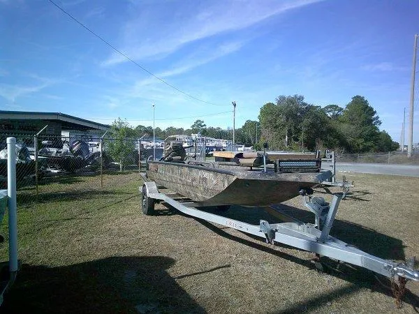 Slide: The Image of Boat on trailer, Excel 1854 SWV4T, 2026 model, parked outdoors near a fence. - 8