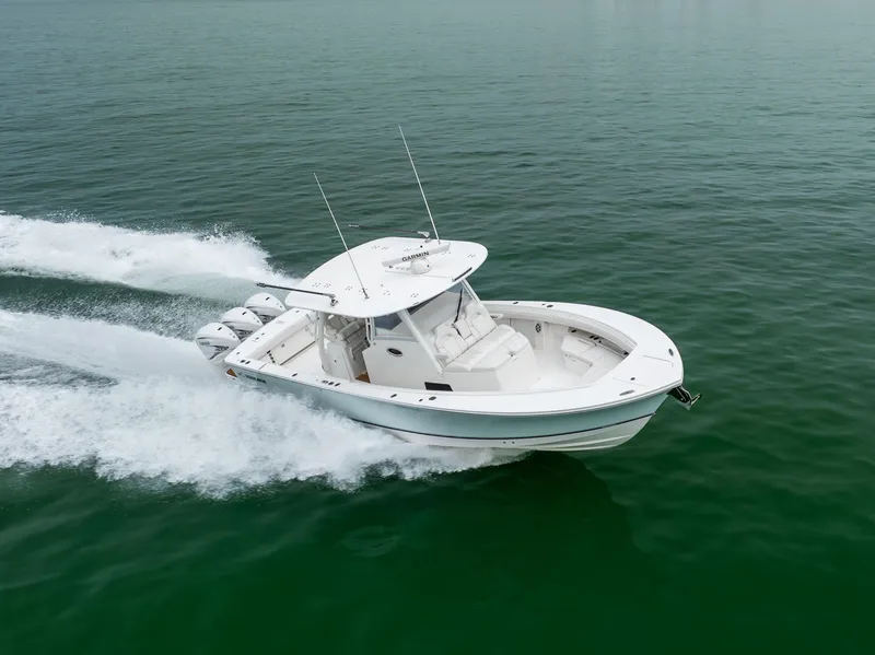 Slide: The Image of 2023 Regulator 37 boat cruising on open water, showcasing sleek design and powerful engines. - 11