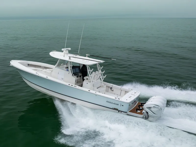 Slide: The Image of 2023 Regulator 37 boat cruising on open water, showcasing sleek design and powerful engines. - 14