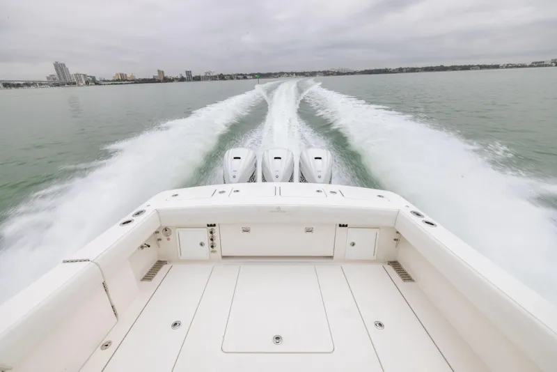 Slide: The Image of 2023 Regulator 37 boat cruising on water, view from stern with powerful engines. - 18