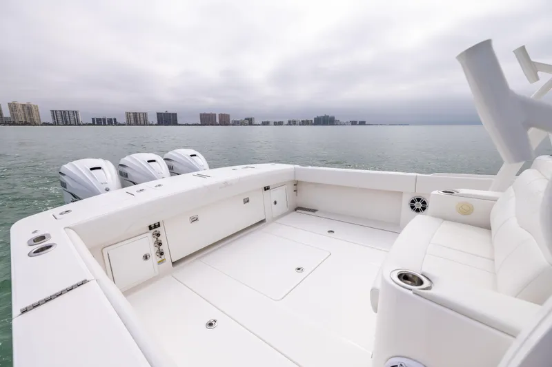 Slide: The Image of 2023 Regulator 37 boat with spacious deck and triple engines on calm water. - 20