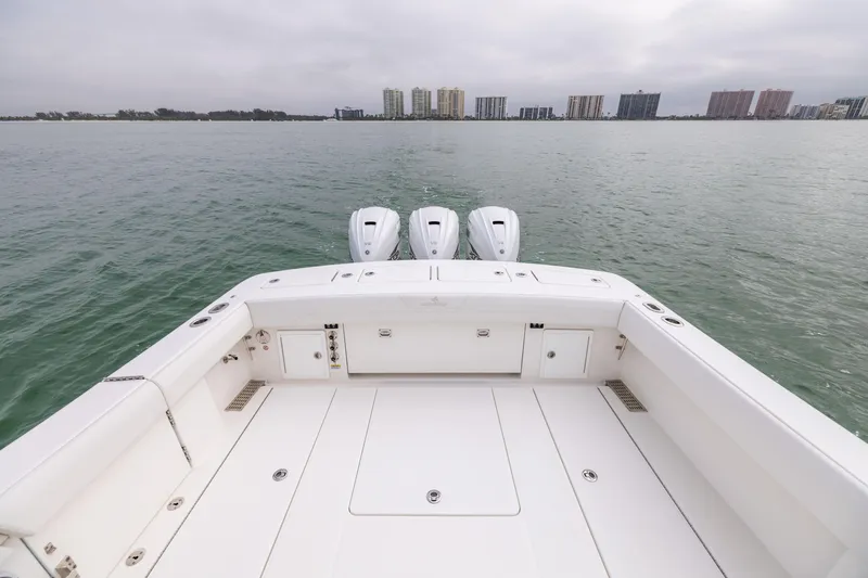 Slide: The Image of 2023 Regulator 37 boat with triple engines on calm water. - 21