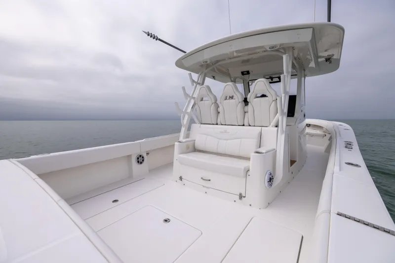 Slide: The Image of 2023 Regulator 37 boat with spacious deck and seating, on calm waters. - 31