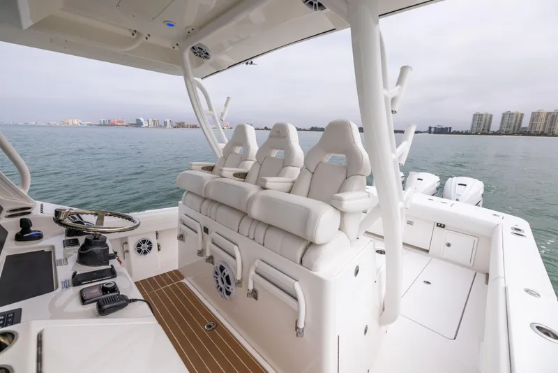 Slide: The Image of 2023 Regulator 37 boat interior with white seating and ocean view. - 32