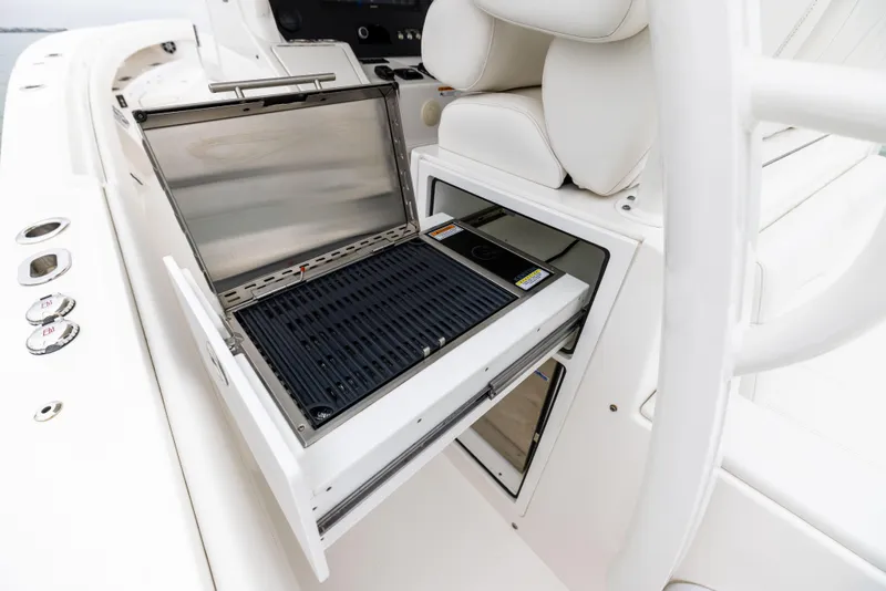 Slide: The Image of 2023 Regulator 37 boat with built-in grill and white seating. - 36