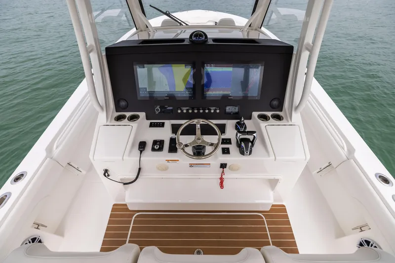 Slide: The Image of 2023 Regulator 37 boat helm with dual screens and modern controls. - 38