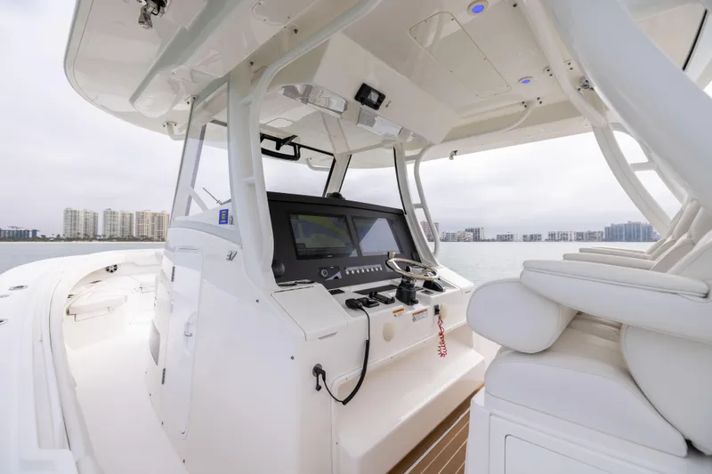 Slide: The Image of 2023 Regulator 37 boat interior with modern helm and seating, overlooking waterfront skyline. - 39