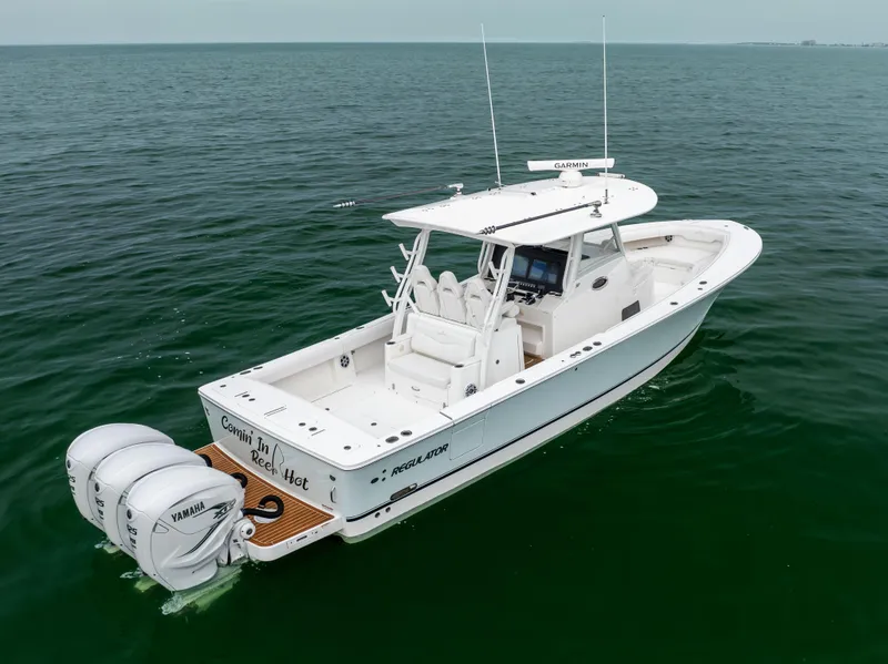 Slide: The Image of 2023 Regulator 37 boat on open water, featuring twin Yamaha engines. - 4
