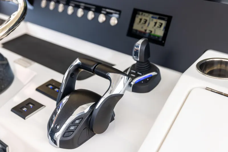 Slide: The Image of Control panel of 2023 Regulator 37 boat with throttle and joystick. - 40
