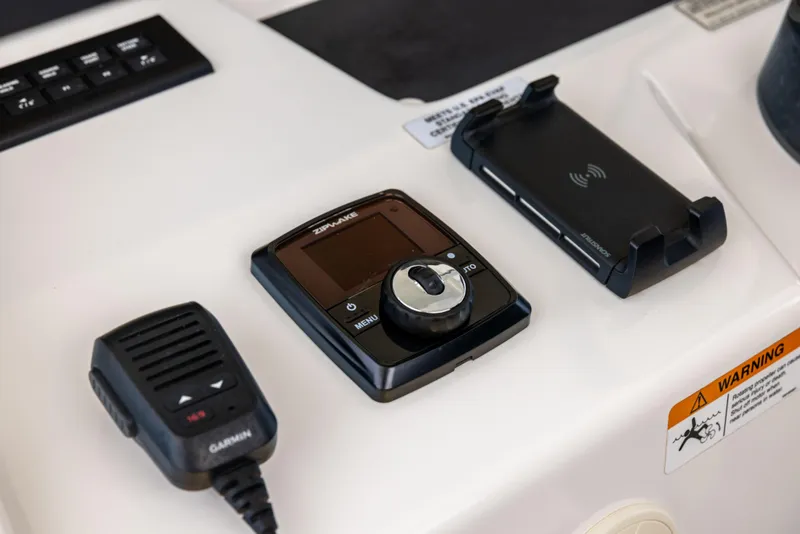 Slide: The Image of 2023 Regulator 37 boat dashboard with Garmin controls and wireless charging pad. - 41