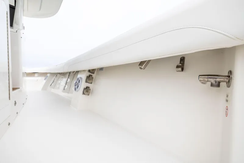 Slide: The Image of 2023 Regulator 37 boat interior detail, showcasing sleek white design and hardware. - 49