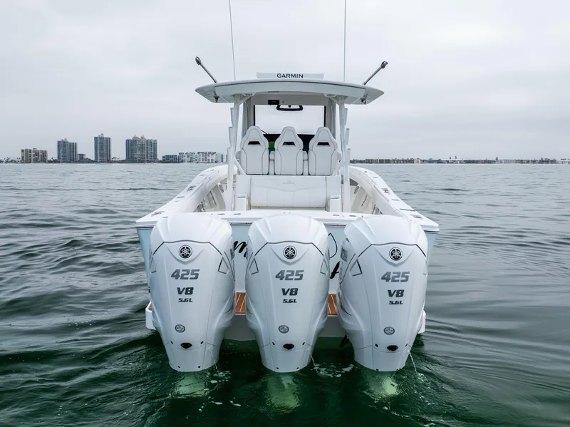 Slide: The Image of 2023 Regulator 37 boat with triple 425 V8 engines on open water. - 7