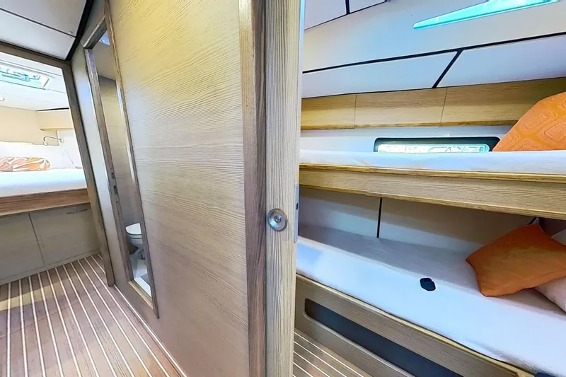 Slide: The Image of 2024 Kufner 54 yacht interior with wooden bunk beds and modern design. - 26
