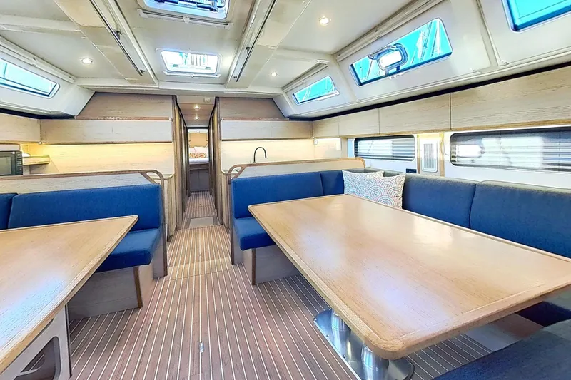 Slide: The Image of Interior of 2024 Kufner 54 yacht with modern seating and wooden tables. - 36
