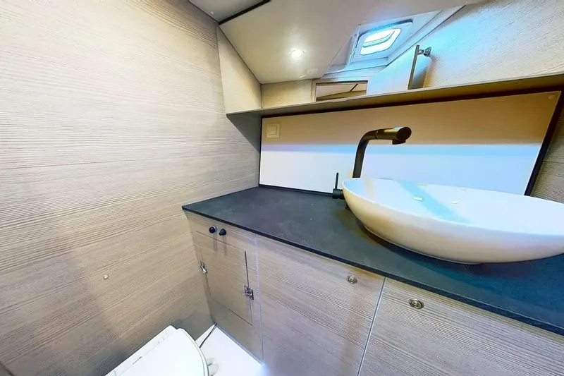 Slide: The Image of Modern bathroom interior on 2024 Kufner 54 yacht, featuring sleek sink and cabinetry. - 43