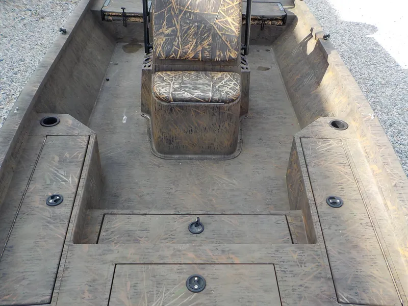 Slide: The Image of 2022 G3 Bay 22 GX boat interior with camo seating and storage compartments. - 11