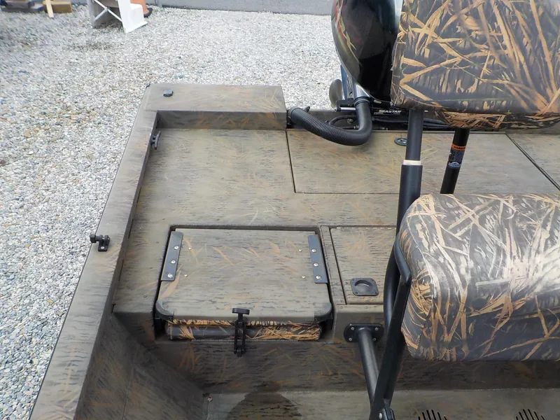 Slide: The Image of 2022 G3 Bay 22 GX boat interior with camo seats and storage compartment. - 13