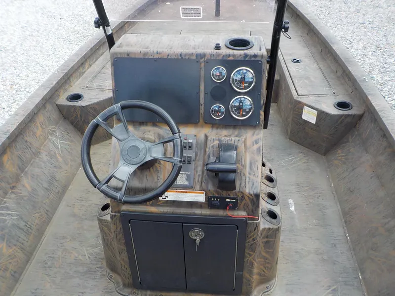 Slide: The Image of 2022 G3 Bay 22 GX boat dashboard with steering wheel and gauges. - 18