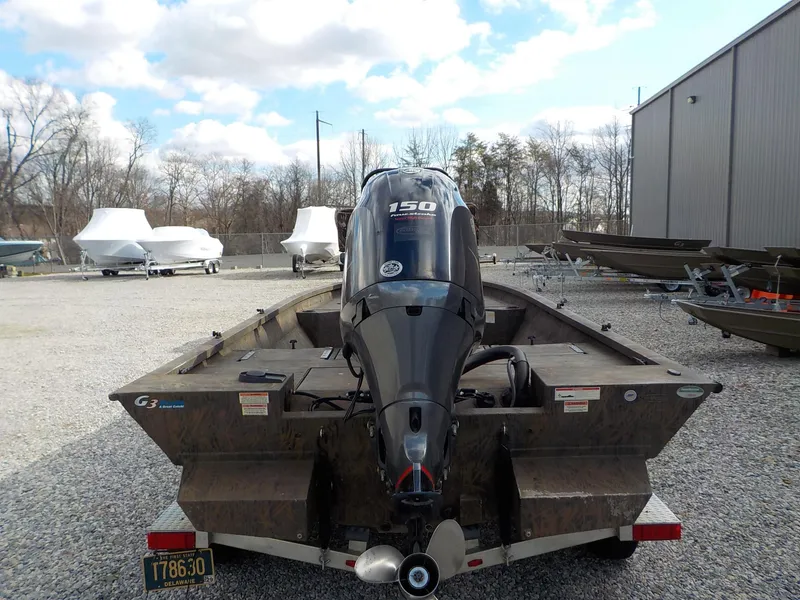 Slide: The Image of 2022 G3 Bay 22 GX boat with 150 HP motor on a gravel lot. - 22