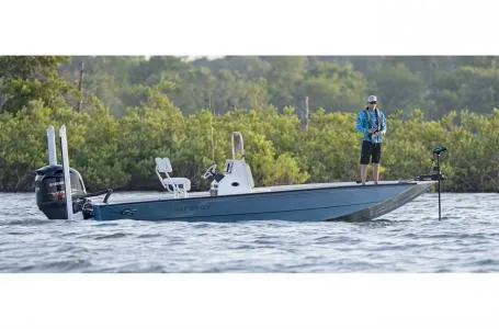 Slide: The Image of 2022 G3 Bay 22 GX boat on water with person fishing, surrounded by greenery. - 25