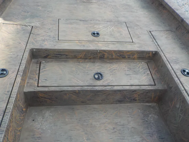 Slide: The Image of 2022 G3 Bay 22 GX boat deck with storage compartments and camo pattern. - 28