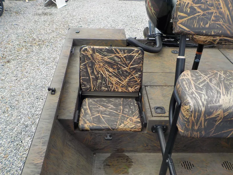 Slide: The Image of 2022 G3 Bay 22 GX boat with camouflage seating and deck, parked on gravel. - 30