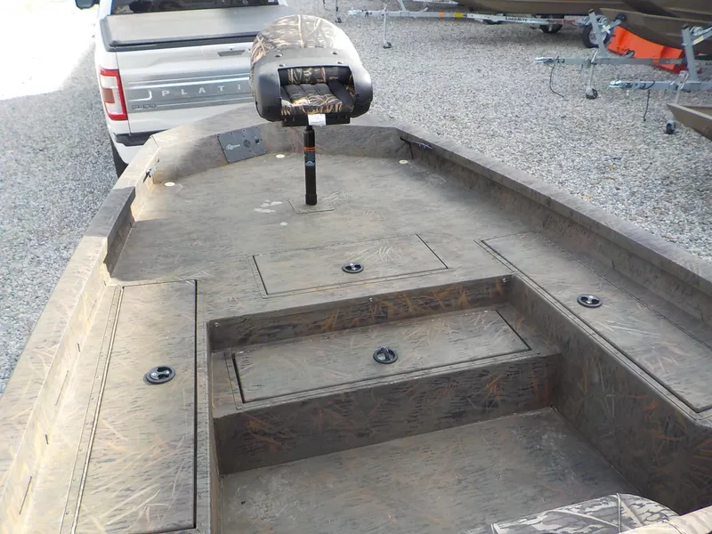 Slide: The Image of 2022 G3 Bay 22 GX boat interior with camo seat and storage compartments. - 9