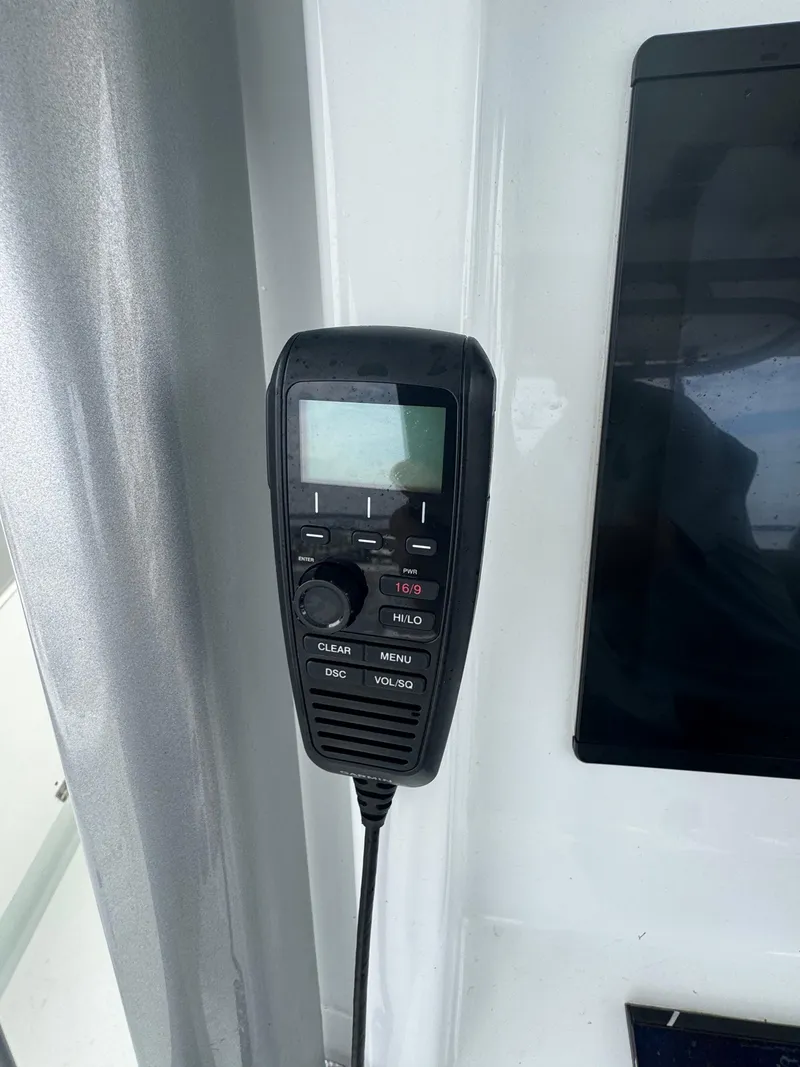 Slide: The Image of VHF radio handset on 2017 Yellowfin 39 Offshore boat dashboard. - 10