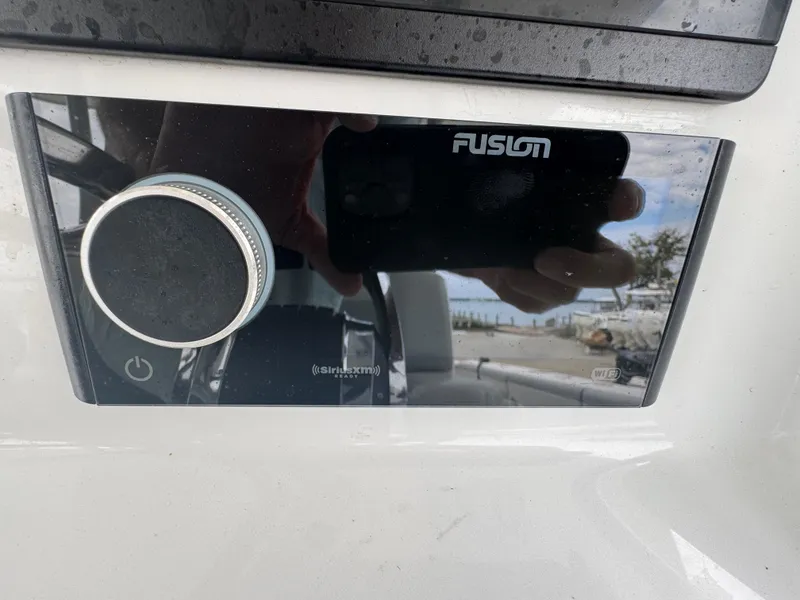Slide: The Image of Fusion stereo system on a 2017 Yellowfin 39 Offshore boat dashboard. - 11