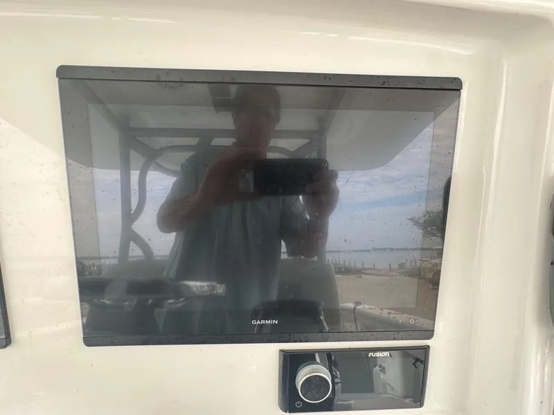 Slide: The Image of 2017 Yellowfin 39 Offshore boat dashboard with Garmin display and Fusion audio system. - 12