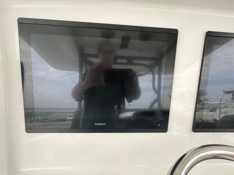 Slide: The Image of Garmin display on 2017 Yellowfin 39 Offshore boat dashboard, reflecting surroundings. - 13