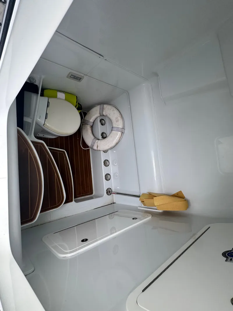 Slide: The Image of 2017 Yellowfin 39 Offshore boat interior with toilet and life preserver. - 14