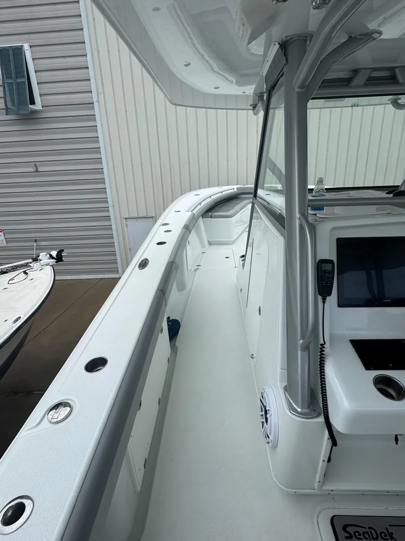 Slide: The Image of 2017 Yellowfin 39 Offshore boat deck with console and rod holders. - 19