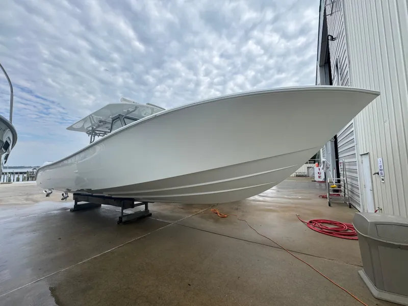 Slide: The Image of 2017 Yellowfin 39 Offshore boat on dry dock under cloudy sky. - 23