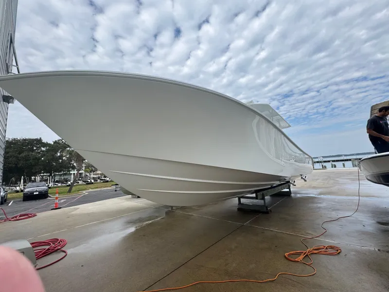Slide: The Image of 2017 Yellowfin 39 Offshore boat on dock, under cloudy sky. - 25